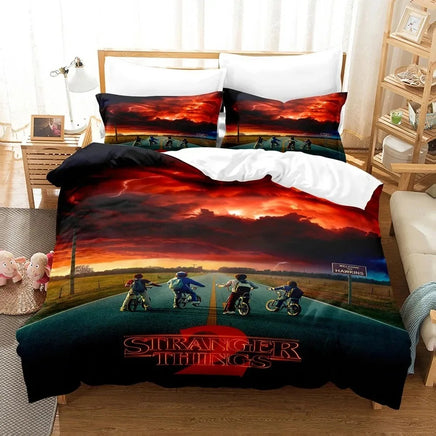 Bedding set with 'Stranger Things' design featuring four children on bikes and a sunset scene.
